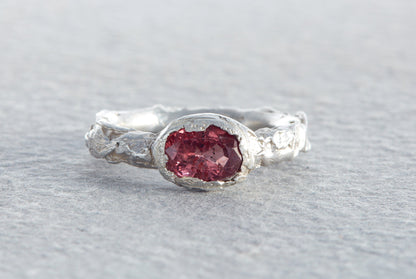 Chunky sculptural sterling silver ring with raspberry sapphire and molten textured organic surface made in North Devon studio