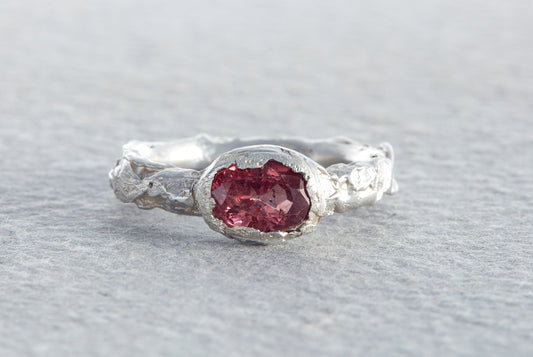 Chunky sculptural sterling silver ring with raspberry sapphire and molten textured organic surface made in North Devon studio
