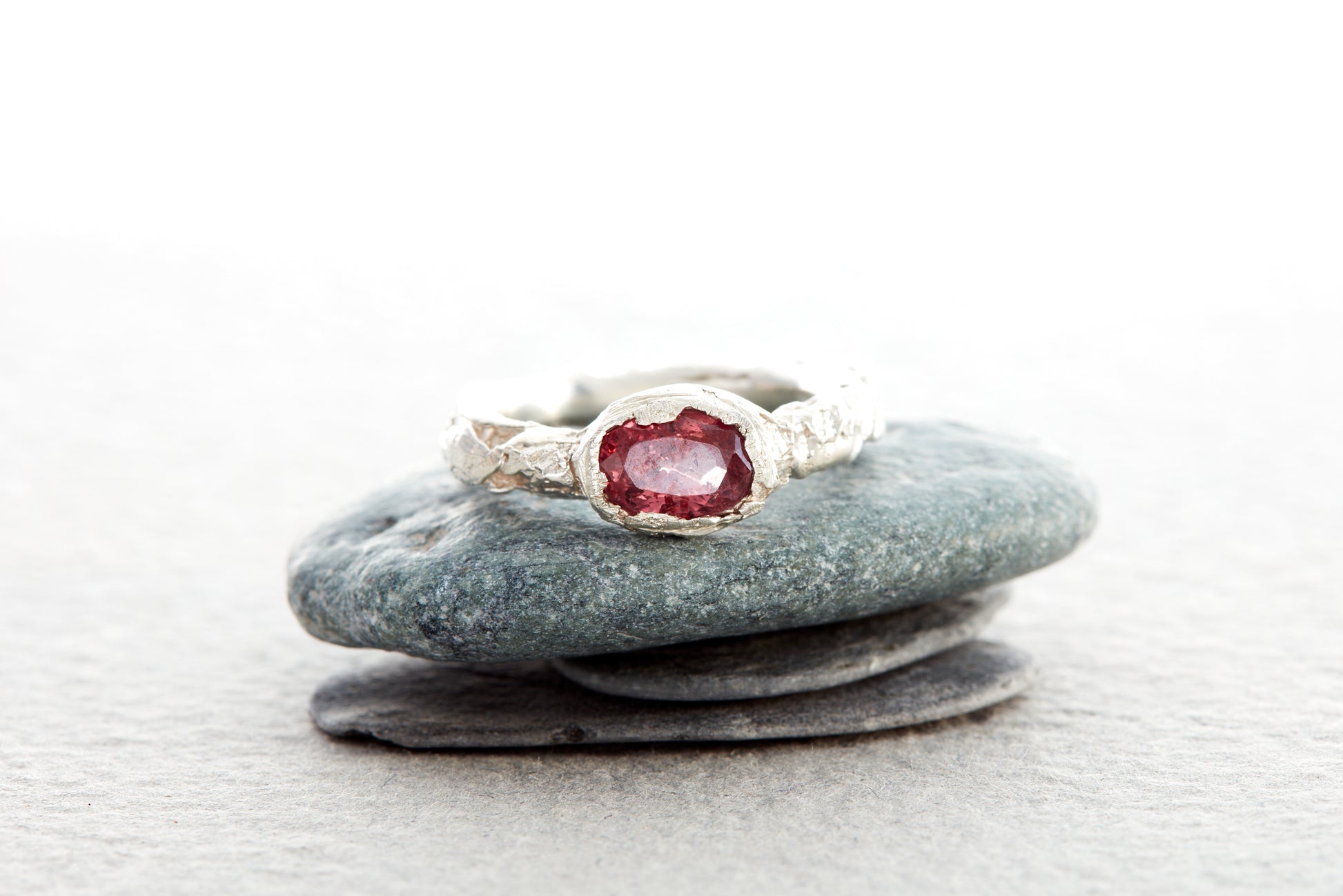 Sterling silver raspberry sapphire ring with sculptural molten texture, handmade in Devon UK